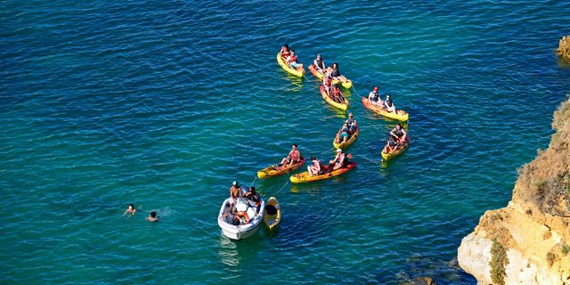 Things to Do in Lagos - Kayak through sea caves, surf at Meia Praia, and explore a historic port town