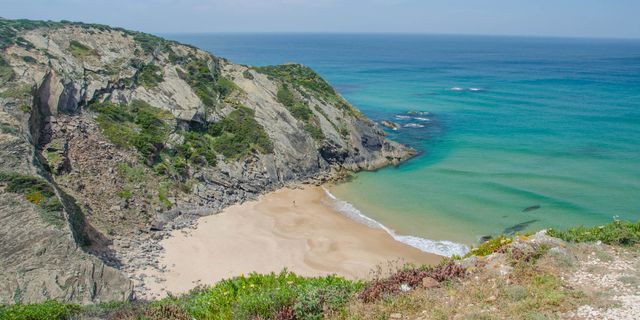 Praia das Adegas - Portugal's clothing-optional cove beneath the dark cliffs of Odeceixe