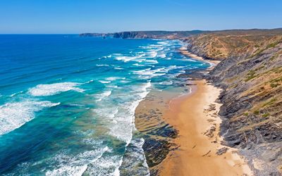 Wide sandy expanse of Praia de Vale Figueiras at low tide
