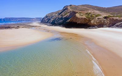 Atlantic waves rolling onto the sand at Praia de Vale Figueiras