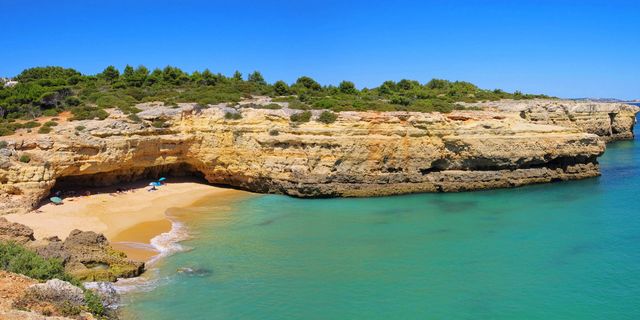 Praia de Albandeira - A tiny cove with a natural rock pool and double arches you can swim through