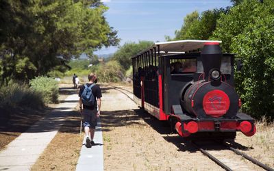 The miniature train crossing the Ria Formosa marshes and saltpans on its way to Praia do Barril