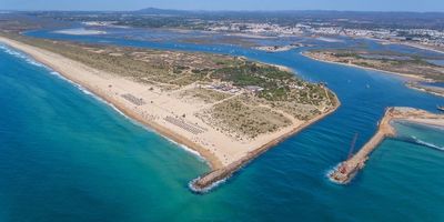 Sweeping view of Ilha de Tavira's golden beach and clear waters