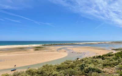 Long stretch of golden sand on Praia de Cacela Velha backed by low dunes