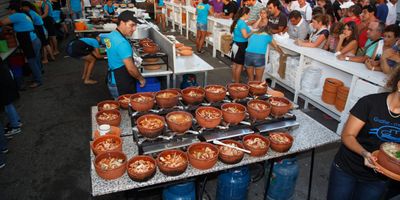 Crowds gathering at the Festival do Marisco on the Olhão waterfront with seafood stalls and the Ria Formosa lagoon behind