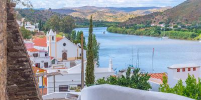 View of Alcoutim village with its church and whitewashed houses overlooking the Guadiana River
