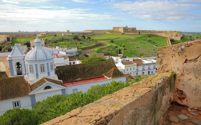 View from the castle walls showing the church dome and bell tower of Castro Marim with the Forte de São Sebastião on the opposite hill