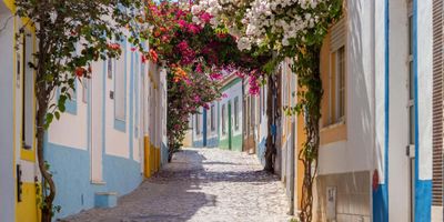Golden sandstone cliffs and turquoise waters along Lagoa's coastline