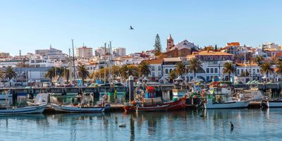 Lagos harbour with traditional fishing boats and the historic town skyline