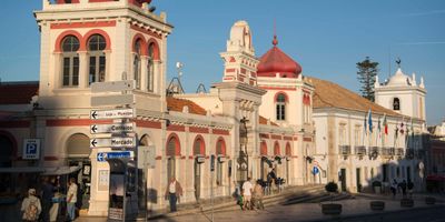 Historic Loulé market building with distinctive red domes and Moorish-revival arched windows