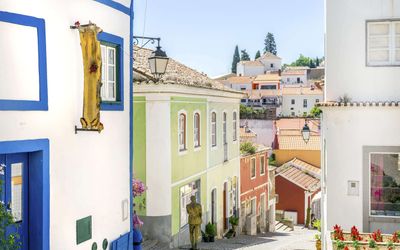 Steep cobbled street in Monchique with traditional buildings and craft shops
