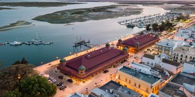 Aerial view of Olhão's iconic waterfront fish markets and Ria Formosa lagoon at dusk