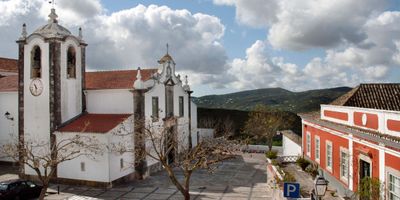 São Brás de Alportel church and town square with Serra do Caldeirão mountains in the background