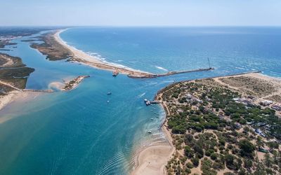 Long stretch of golden sand beach on Ilha de Tavira backed by natural dunes