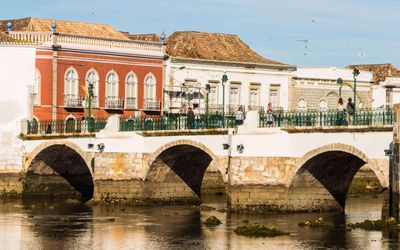 The historic Ponte Romana spanning the Gilão River in central Tavira