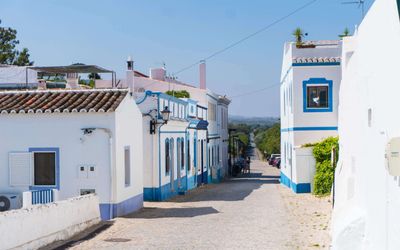 Whitewashed houses of Cacela Velha along a quiet lane overlooking the Ria Formosa lagoon