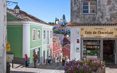 Restored buildings and shaded walkways in the Caldas de Monchique hamlet surrounded by wooded hills